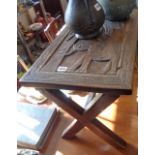 African carved hardwood coffee table on "X" frame base