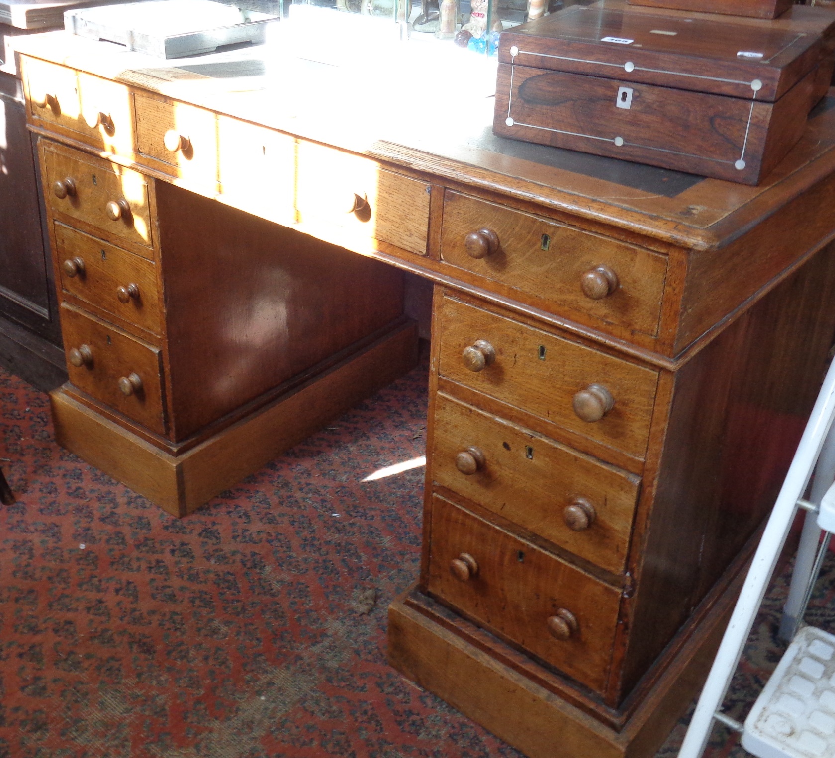 Victorian oak pedestal nine drawer kneehole desk with leather inset top and turned bun handles