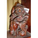 Oriental carved hardwood figure of a happy peasant, 7" tall