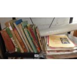 Shelf of old cookery books, programmes, sheet music and posters