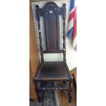 18th c. oak side chair having carved arched top rail above panelled back, flanked by turned uprights