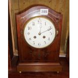Edwardian inlaid mahogany arch topped mantle clock with French movement, striking on a gong and