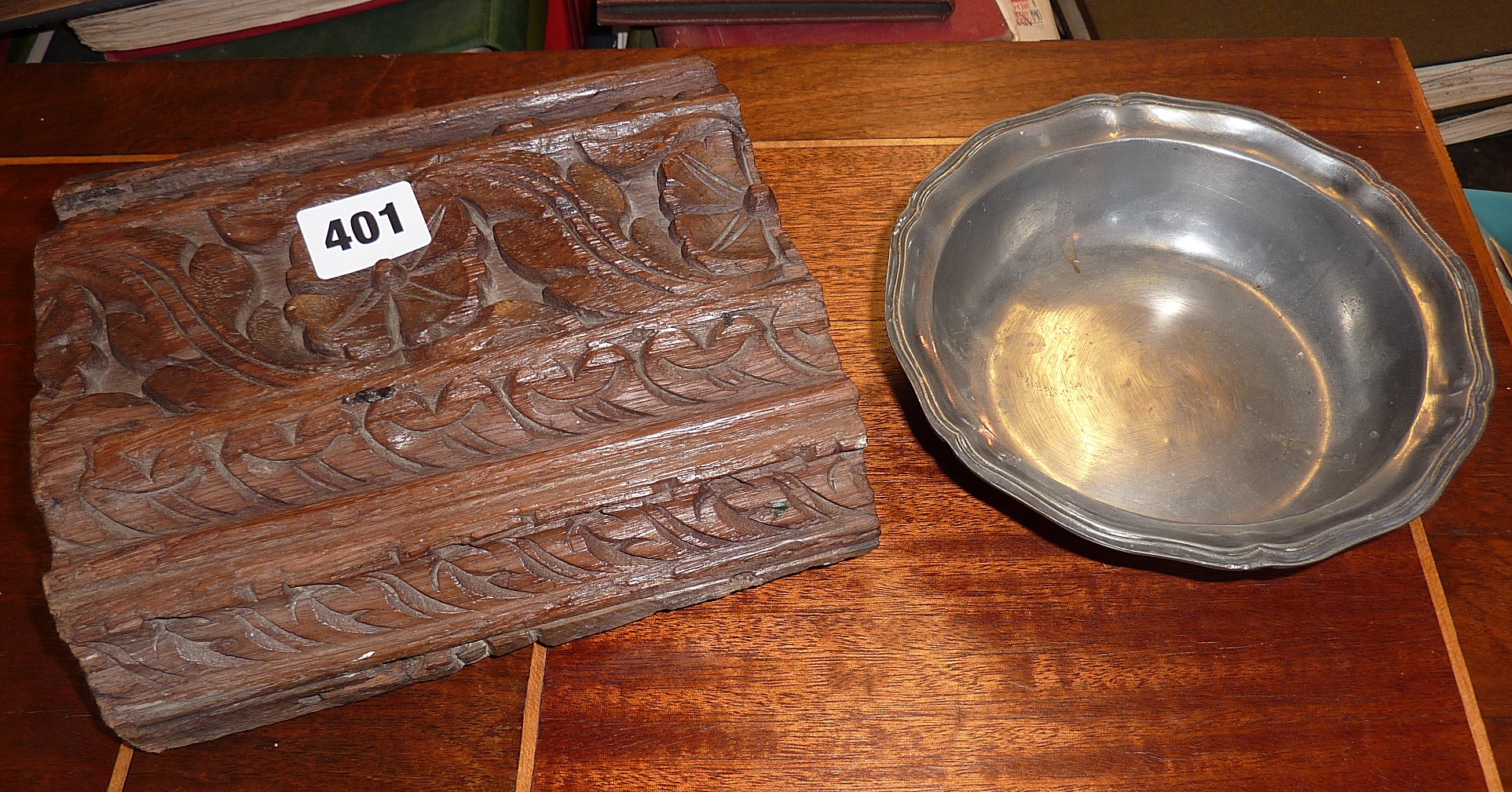 A section of a 17th c. carved oak beam and a pewter bowl
