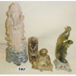 A group of four oriental carved hardstone and soapstone figures, inc. a peacock