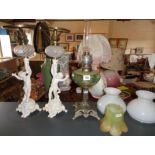 Art Nouveau oil lamp with painted glass reservoir above metal base and a pair of Victorian painted