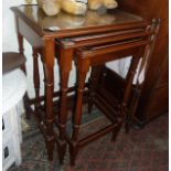 Tall nest of three mahogany tables with galleried top above turned legs