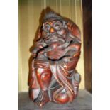 Oriental carved hardwood figure of a happy peasant, 7" high