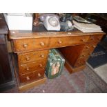 Victorian oak pedestal nine drawer kneehole desk with leather inset top and turned bun handles