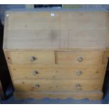 Pine bureau with fitted interior above two over two drawers