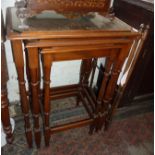 Tall nest of three mahogany tables with galleried top above turned legs