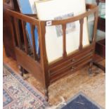 Edwardian mahogany four-section Canterbury with two drawers under, and with brass castors