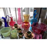 Collection of assorted coloured glassware including Cranberry, overlay blue glass and vaseline glass