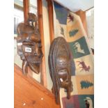 Three carved wooden tribal masks and a Canadian woven hanging