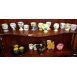 Collection of assorted pottery egg cups