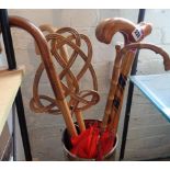 Four walking sticks and a carpet beater