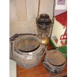 Set of three graduated cast iron crocks on chains by Holcroft and a Tilley lamp