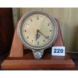 A Smiths car clock on wood stand