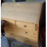 Pine bureau with fitted interior above two over two drawers