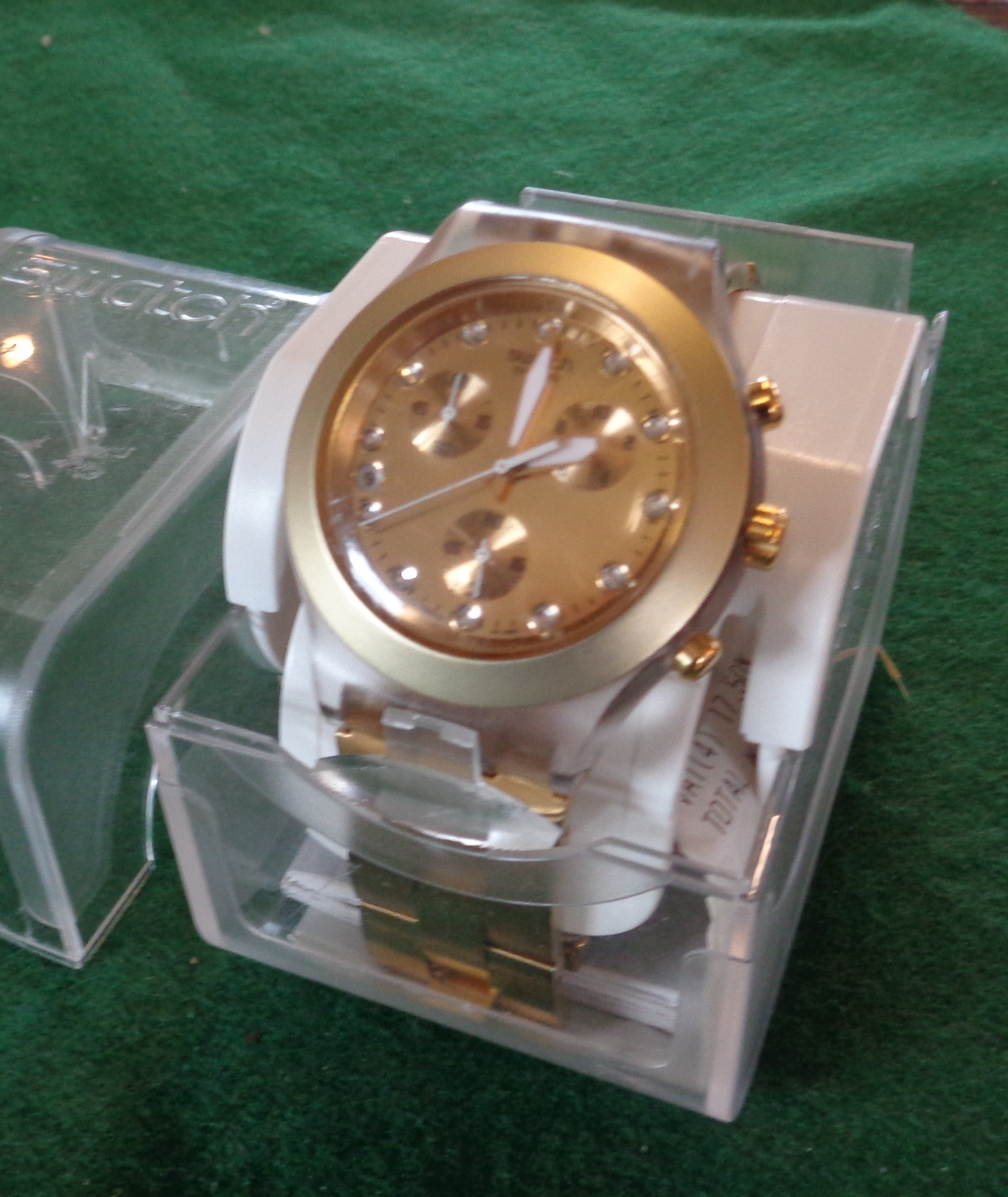 Gold coloured chunky men's Swatch watch in case