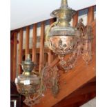 Pair of Art Nouveau bronze wall oil lamps with ornate brackets and glass reservoirs