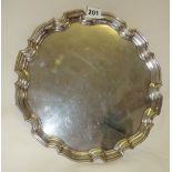 Large hallmarked silver salver with gadrooned edge, and 3 claw feet under. Approx 23 troy oz., 12"