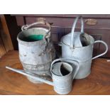 Old galvanised well bucket and two watering cans