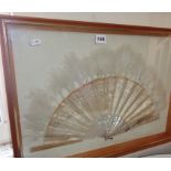 Embroidered antique silk and feather fan with mother-of-pearl sticks and guards, mounted in wall