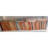 Shelf of assorted orange Penguin paperback novels