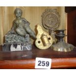 Putti figure set on marble plinth, an ornate brass tie back and two other brass items