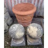 Pair of stone finials and a terracotta urn