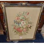 Large Victorian woolwork picture of a still life of flowers in ornate gilt gesso and black frame