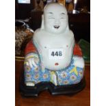 Chinese porcelain Buddha on shaped hardwood stand, 20cm high