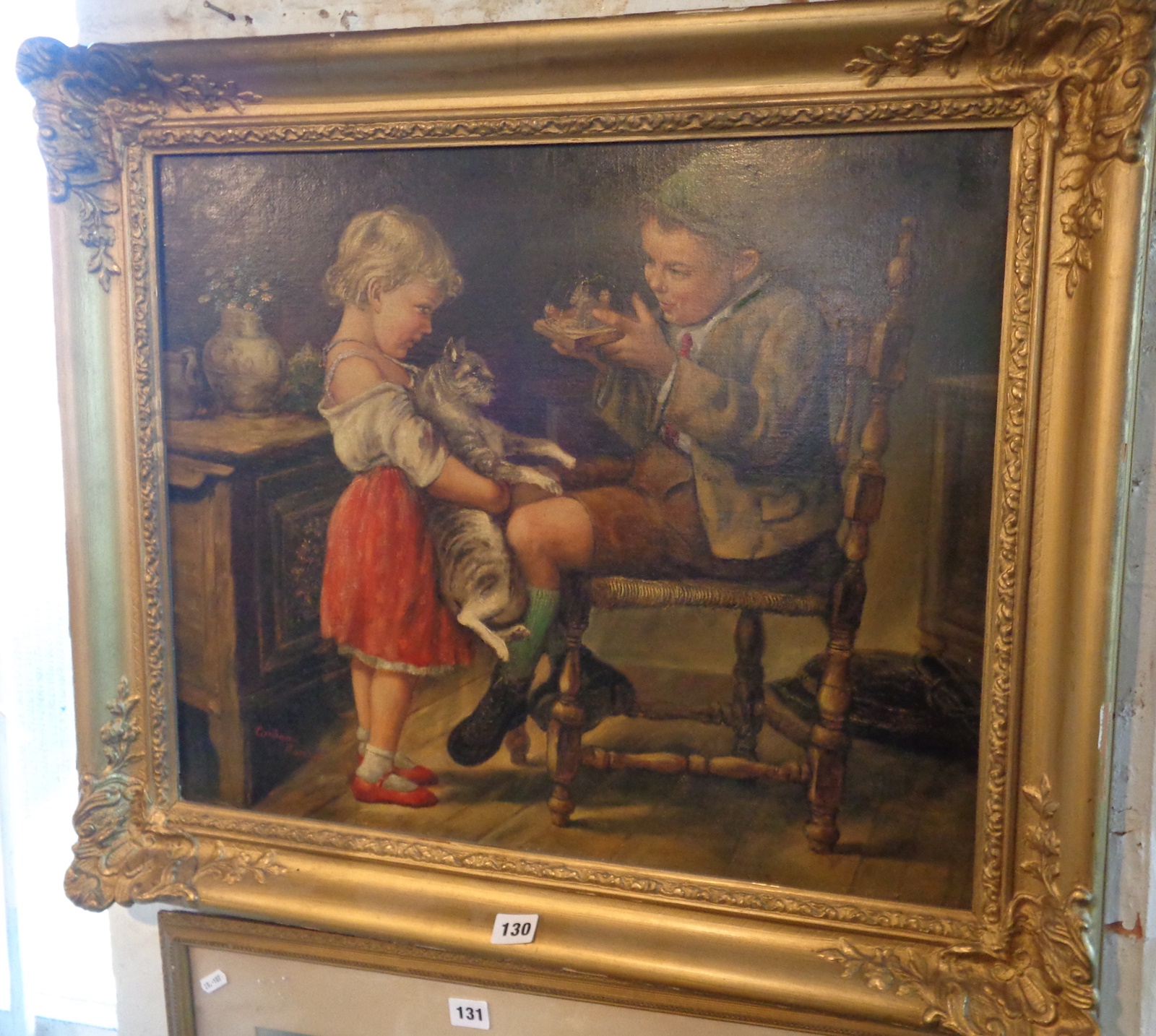 Corbeau BARISON, oil on canvas of two children with a cat in an interior scene, signed, 63cms x