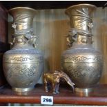 Pair Chinese brass vases with dragons and impressed character mark to the base, 25cms high and a