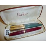 Parker fountain pens and pencil in case, including a maroon Parker Duofold and a Dove Grey Parker 51