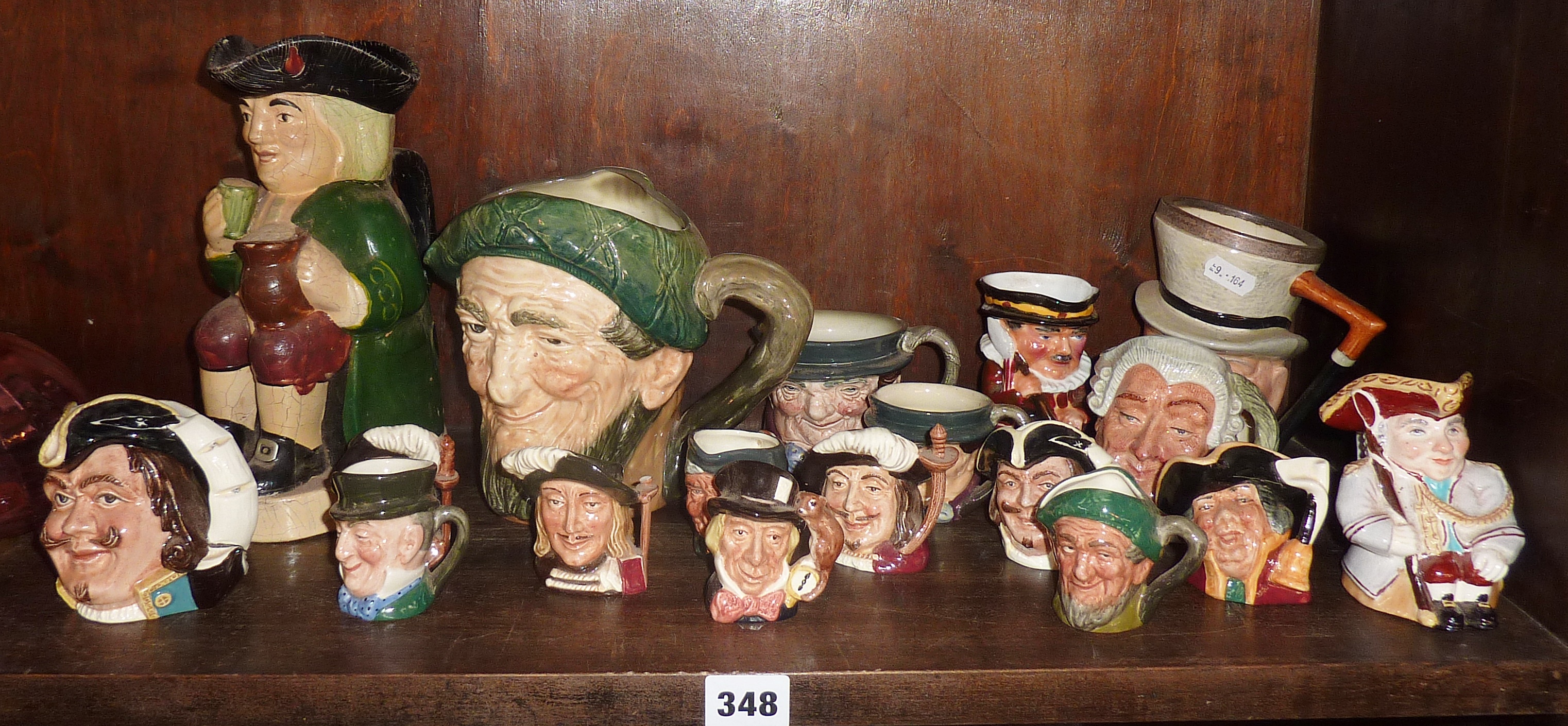 Shelf of miniature Royal Doulton character jugs and others