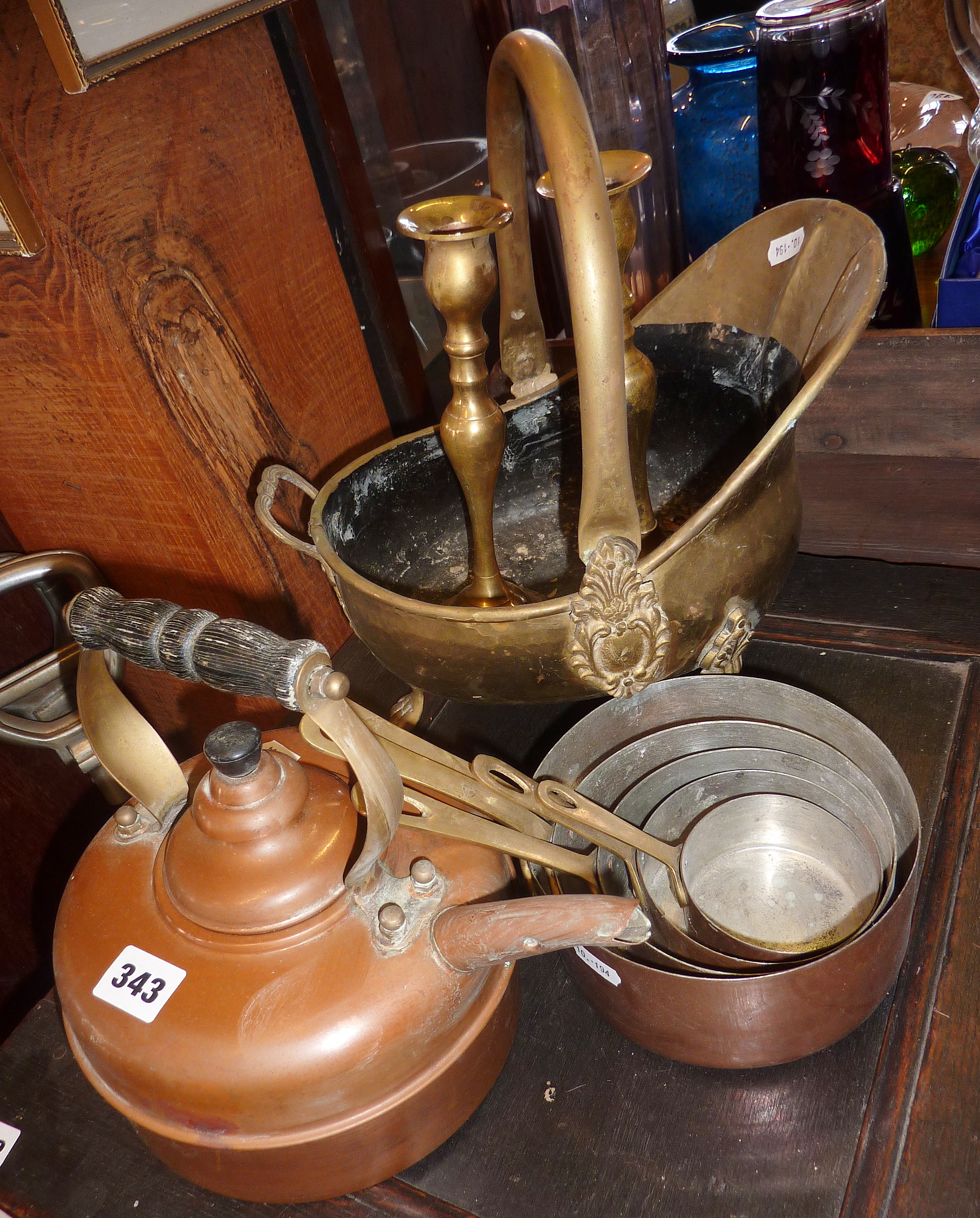 Old copper kettle, brass coal scuttle and a set of five copper saucepans