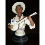 Continental majolica black boy playing the banjo, approx 10" high