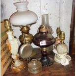 Four various oil lamps and three onyx table lamps