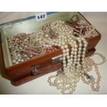 Leather case containing vintage costume pearl necklaces, earrings, etc.