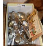 Box of silver plated cutlery and comical postcards