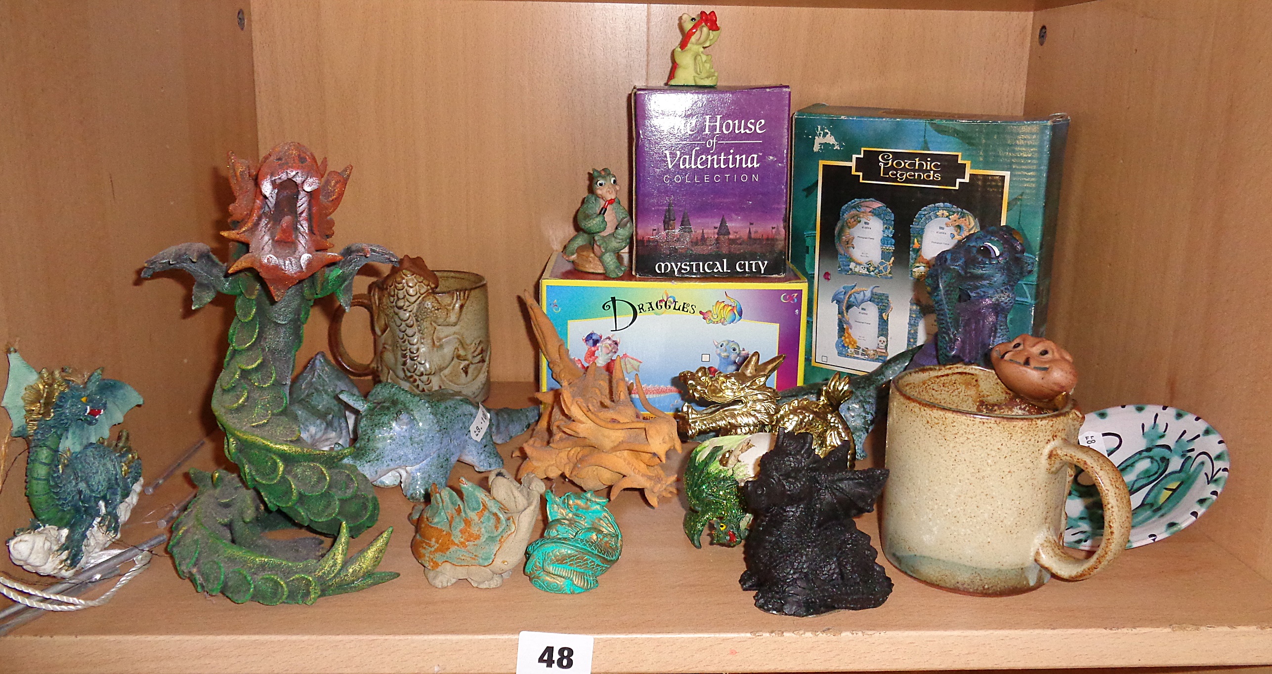 Shelf of assorted dragon ornaments