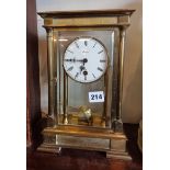 A four glass brass library mantle clock, the eight-day movement striking on a bell, 29cm