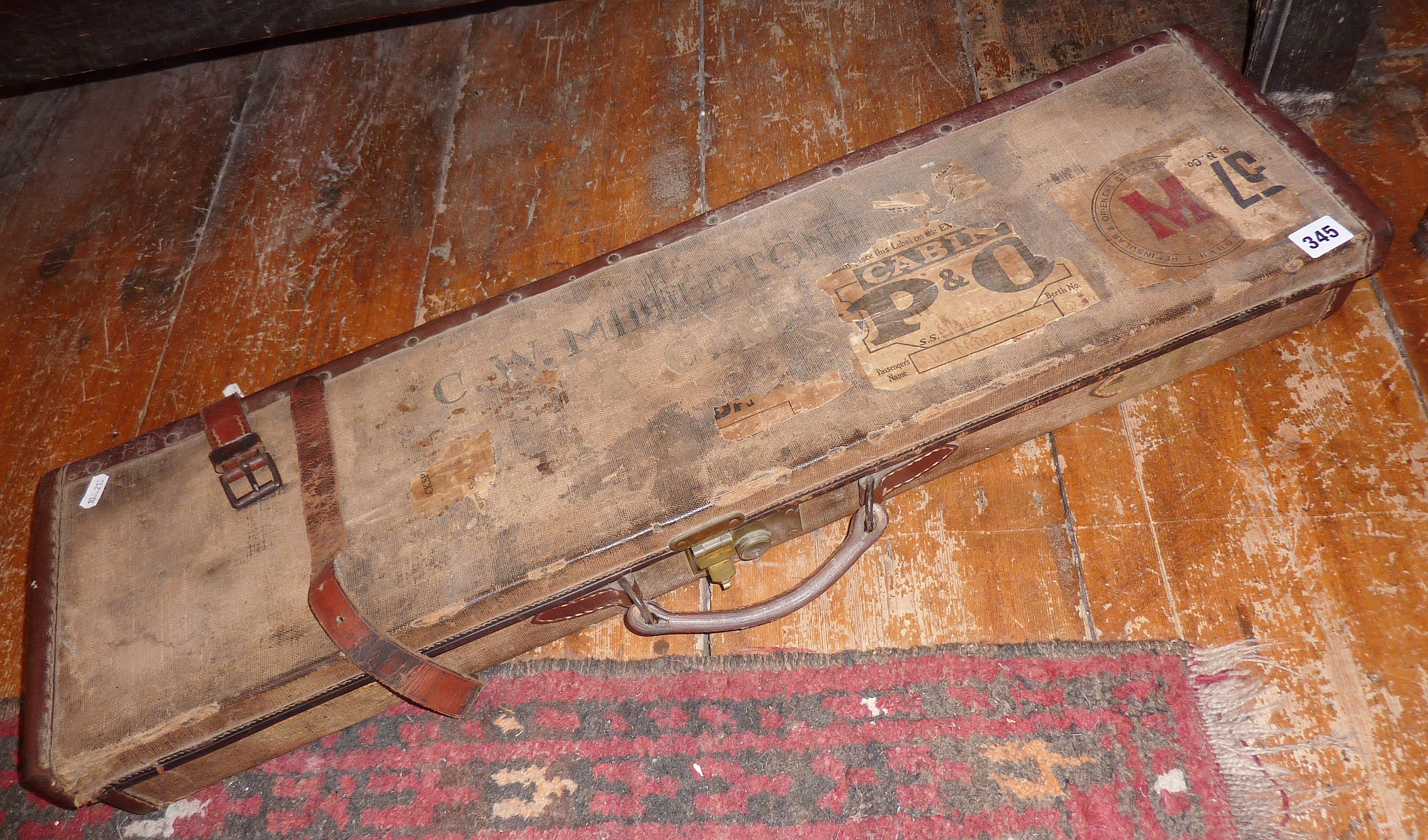 Old Edwardian canvas covered rifle or gun case, with luggage labels to exterior, leather bound