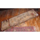 Old Edwardian canvas covered rifle or gun case, with luggage labels to exterior, leather bound