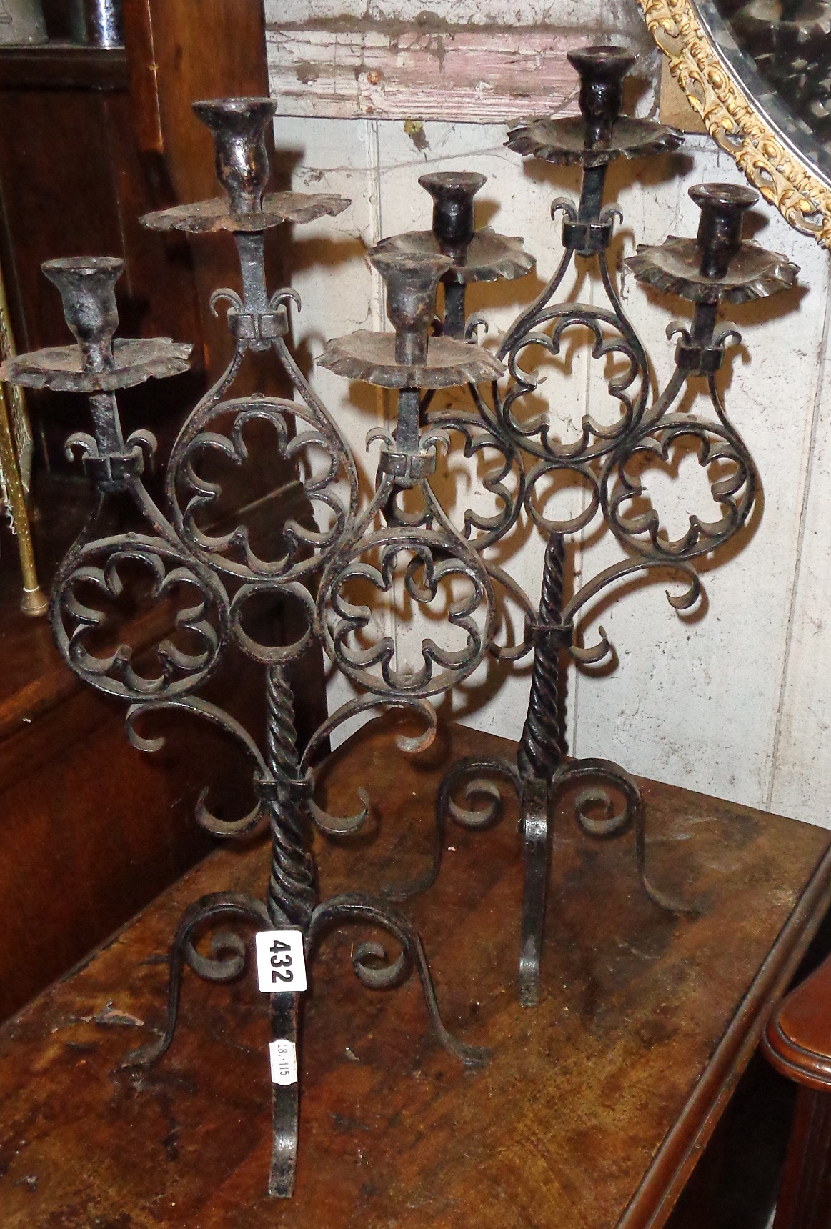 Pair of wrought iron candelabra and a similar three-fold table mirror