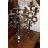 Pair of wrought iron candelabra and a similar three-fold table mirror