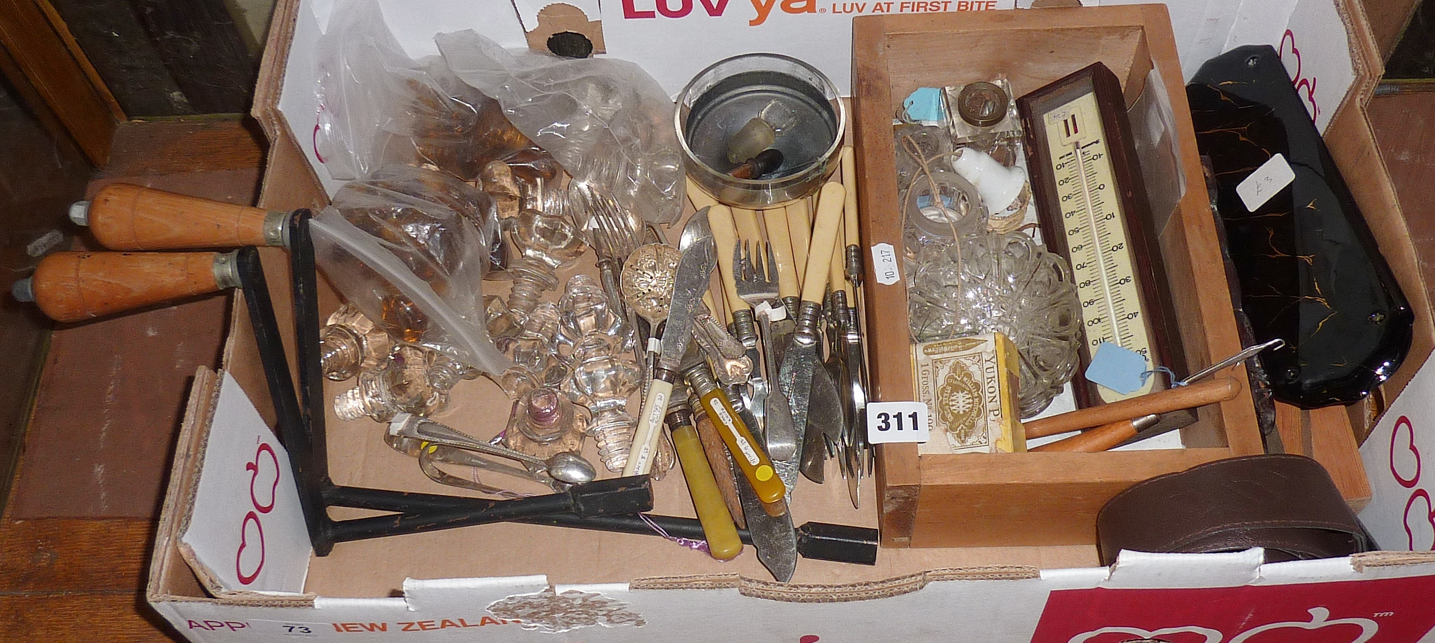 Box of assorted cutlery, two wind-out table handles, thermometer etc