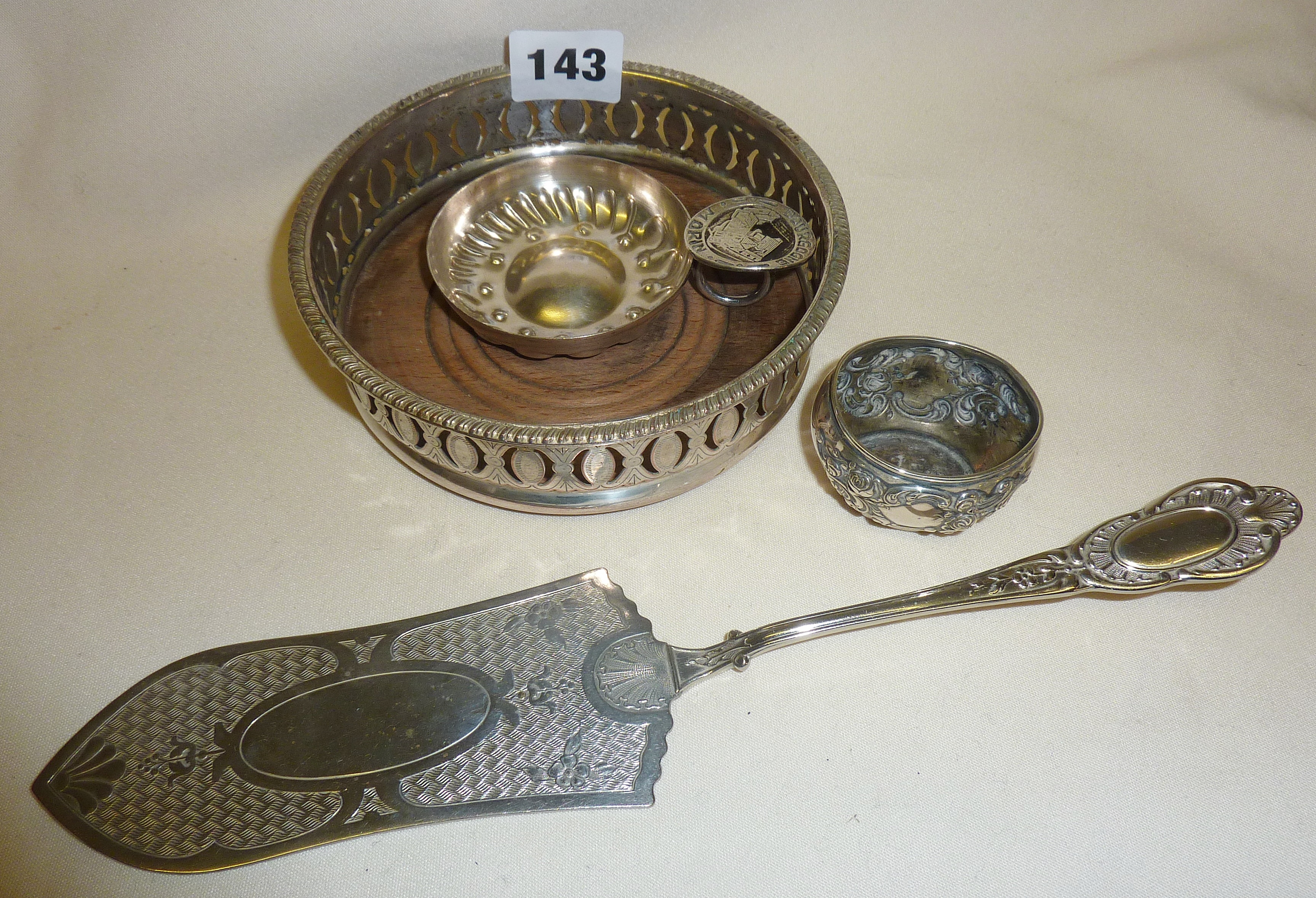 Silver plated wine taster, coaster and cake slice with a hallmarked silver salt pot