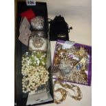 Two boxes of assorted vintage costume jewellery, small silver bangle, and a 1930's leather clutch